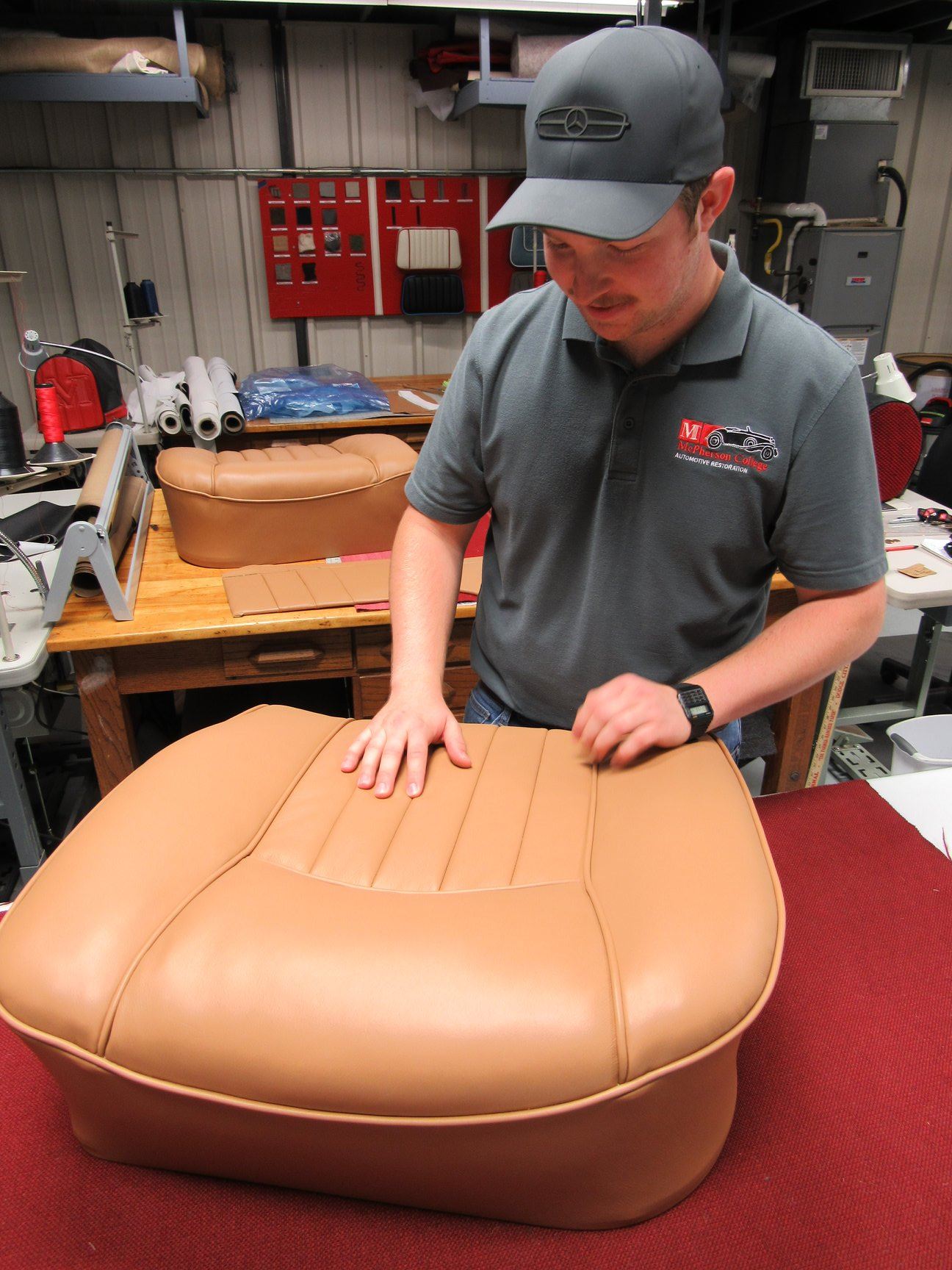 McPherson College Automotive Restoration Student with reupholstered car seat